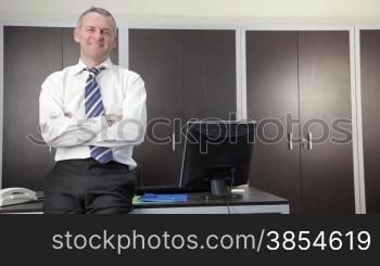 multiple shots of mid adult businessman looking at camera in office
