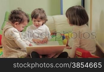 multiple shots of toddler and 2-3 years old girls playing with pc in kindergarten.