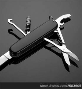 multipurpose folding knife on a black background. Swiss army knife. folding knife on a black background