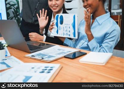 Multiracial analyst team use BI dashboard data to analyze financial report on meeting table. Group of diverse business people utilize data analysis by FIntech for success business marketing. Concord. Multiracial analyst team use BI dashboard for data analysis with laptop. Concord