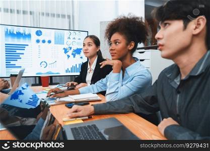 Multiracial analyst team use BI dashboard data to analyze financial report on meeting table. Group of diverse business people utilize data analysis by FIntech for success business marketing. Concord. Multiracial analyst team use BI dashboard for data analysis with laptop. Concord