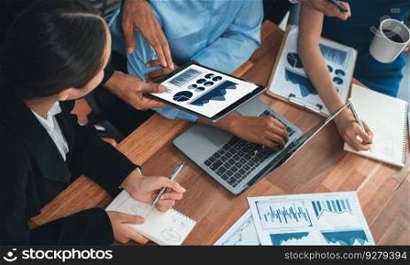 Multiracial analyst team use BI Fintech software to analyze financial data on meeting table. Financial dashboard data display on laptop screen with analyzed chart for marketing indication. Concord. Financial dashboard data display on laptop screen. Concord
