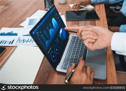 Multiracial analyst team use BI Fintech software to analyze financial data on meeting table. Financial dashboard data display on laptop screen with analyzed chart for marketing indication. Concord. Financial dashboard data display on laptop screen. Concord