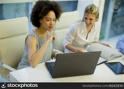 Multiracial businesswomen on meeting in modern office brainstorming, working on laptop