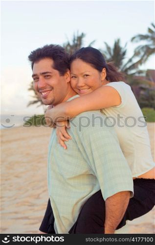 Multiracial Couple Embracing on Hawaiian Beach