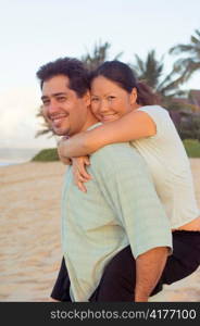 Multiracial Couple Embracing on Hawaiian Beach