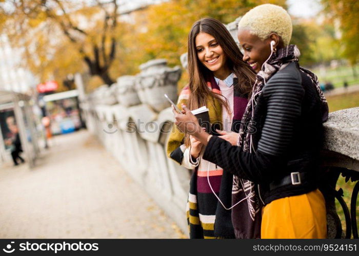 Multiracial female friends drinking coffee outdoor