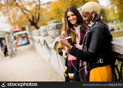 Multiracial female friends drinking coffee outdoor