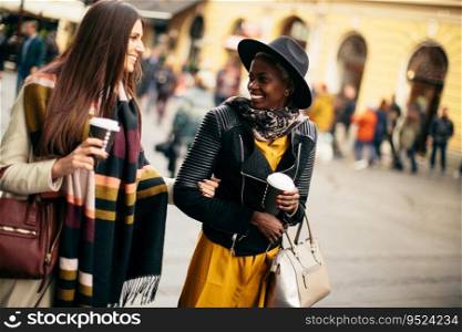 Multiracial female friends drinking coffee outdoor