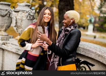 Multiracial female friends taking selfie outdoor