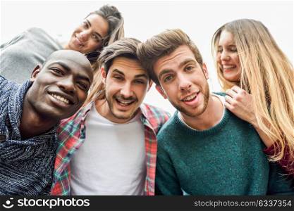 Multiracial group of friends taking selfie in a urban park