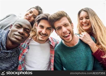 Multiracial group of friends taking selfie in a urban park
