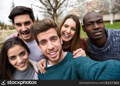 Multiracial group of friends taking selfie in a urban park