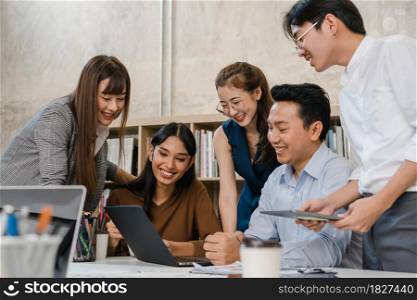Multiracial group of young creative people in casual wear meeting brainstorming ideas about new paperwork project colleagues working together planning success strategy enjoy teamwork in small office