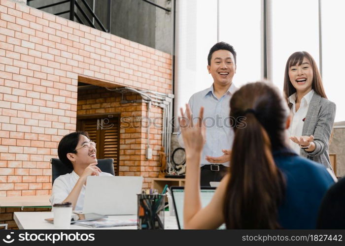 Multiracial group of young creative people in casual wear meeting brainstorming ideas about new paperwork project colleagues working together planning success strategy enjoy teamwork in small office