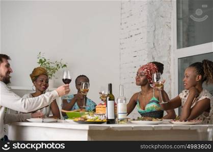 Multiracial Group Of Young Friends Enjoying Meal at Home