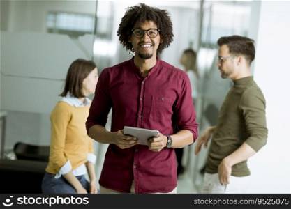 Multiracial people standing in the office holding digital tablet