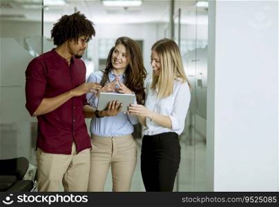 Multiracial people standing in the office holding digital tablet
