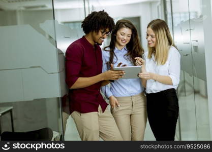 Multiracial people standing in the office holding digital tablet