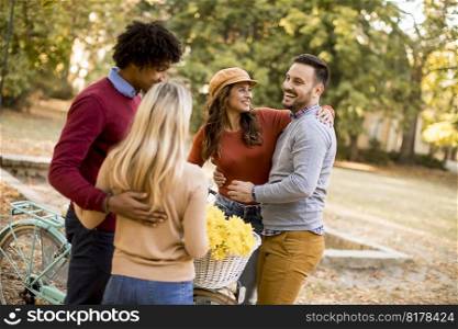 Multiracial young people walking in the autumn park and having fun