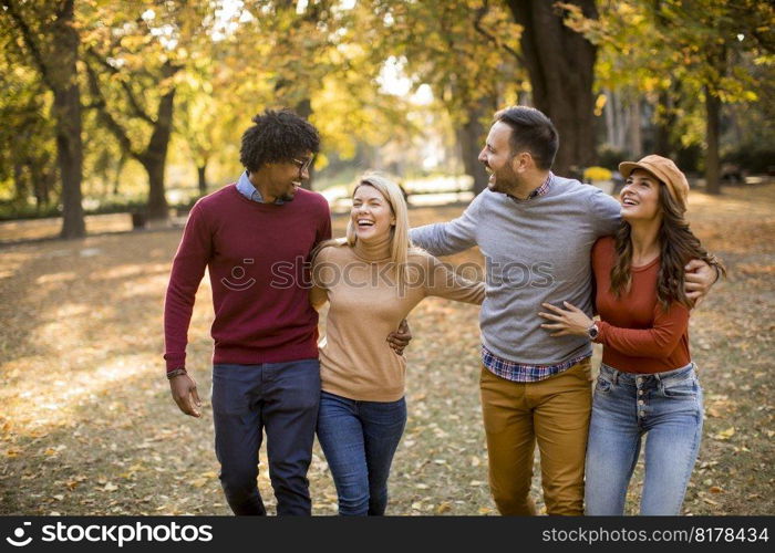 Multiracial young people walking in the autumn park and having fun