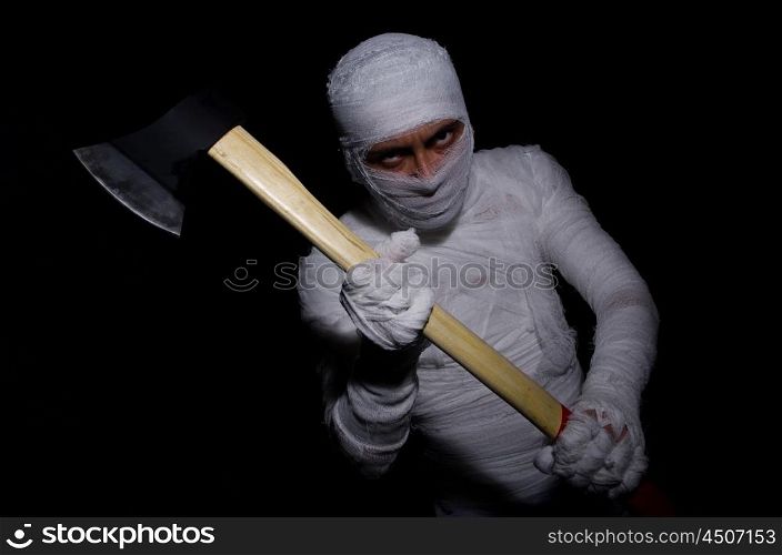 Mummy with axe in halloween concept