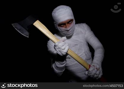 Mummy with axe in halloween concept