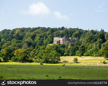 Muncaster Castle nestles in woodland on the edge of Lake District in England