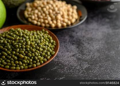 Mung bean and Soy bean on the plate on a black cement floor background.