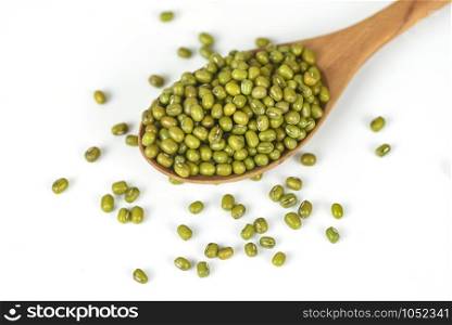 Mung beans on wooden spoon on white background / Bean seed cereal whole grains