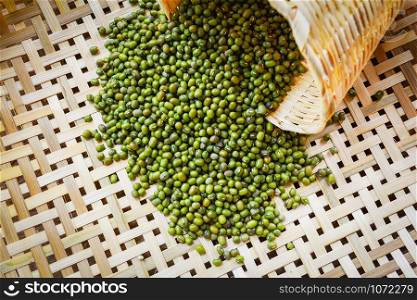 Mung beans or Green beans seed cereal whole grains on bamboo threshing basket background in selective focus - food high protein