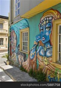 Murals of female faces on exterior wall, Valparaiso, Chile