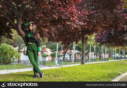 Murcia, Spain, April 15, 2019: Atractive Happy Woman Standing by a bird-cherry tree in a park in Mucia, Spain.. Atractive Happy Woman Standing by a bird-cherry tree in a park in Mucia, Spain.