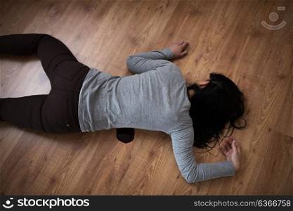 murder, kill and people concept - dead woman body in blood lying on floor at crime scene (staged photo). dead woman body in blood on floor at crime scene