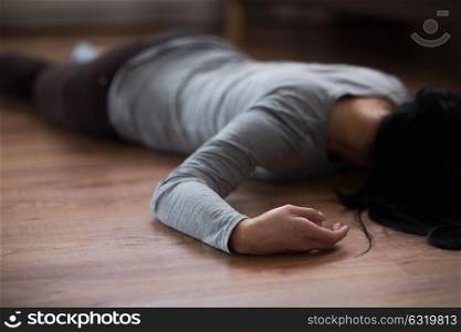 murder, kill and people concept - unconscious or dead woman body lying on floor at crime scene. dead woman body lying on floor at crime scene