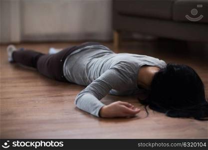 murder, kill and people concept - unconscious or dead woman body lying on floor at crime scene (staged photo). dead woman body lying on floor at crime scene