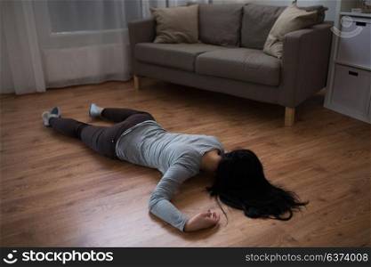 murder, kill and people concept - unconscious or dead woman body lying on floor at crime scene (staged photo). dead woman body lying on floor at crime scene