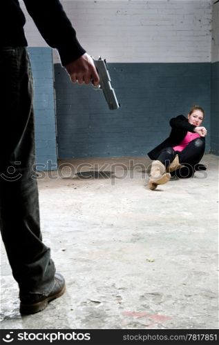 Murderer, holding a gun, face to face with a terrified woman