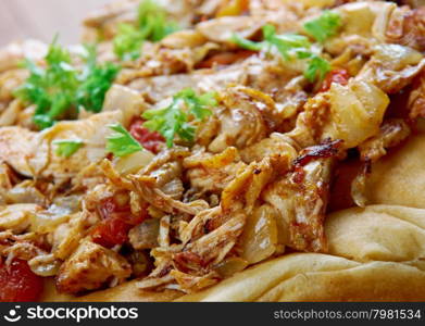 Musakhan - Jordanian and Palestinian dish.roasted chicken baked with onions, sumac, allspice, saffron, served over taboon bread.