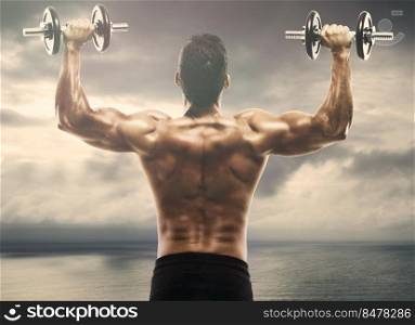 Muscle man lifting weights on outdoor
