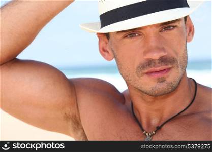 Muscled young man with a hat