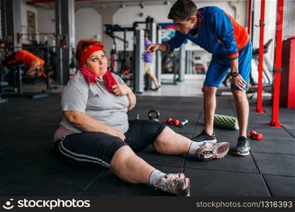 Muscular athlete doing exercise with dumbbells in gym. Bearded man in sport club, healthy lifestyle. Athlete doing exercise with dumbbells in gym