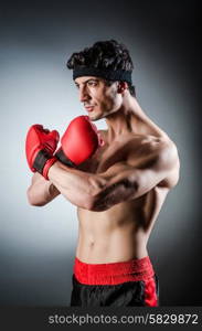 Muscular boxer wiith red gloves