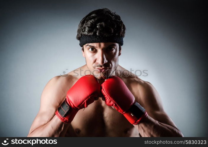 Muscular boxer wiith red gloves