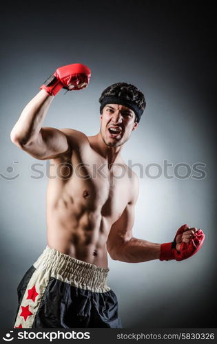 Muscular boxer wiith red gloves