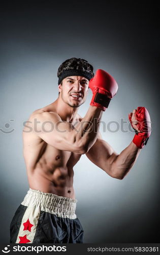 Muscular boxer wiith red gloves