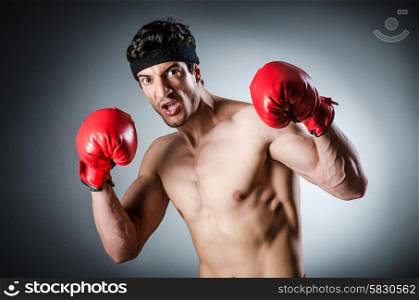 Muscular boxer wiith red gloves