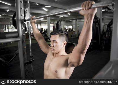 Muscular fitness man bodybuilder is workout in gym