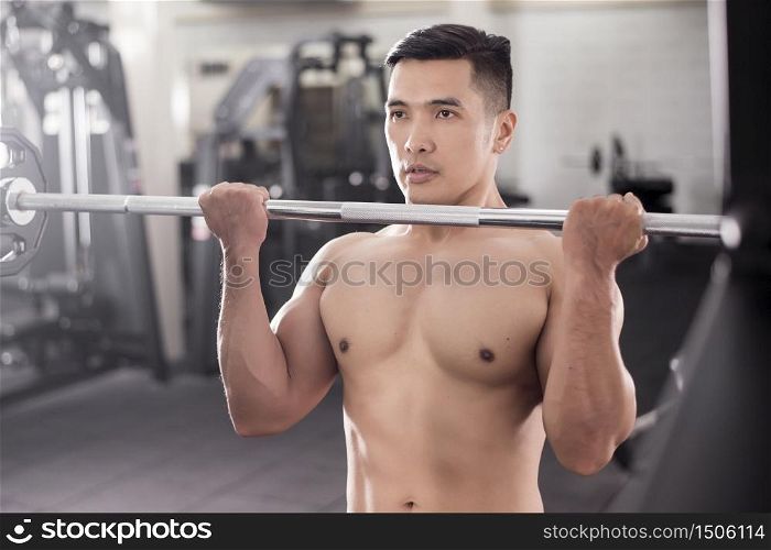 Muscular fitness man bodybuilder is workout in gym
