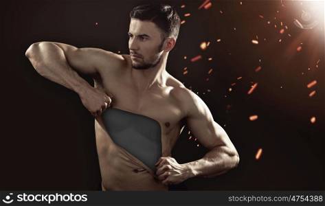 Muscular guy pulling his chest skin away